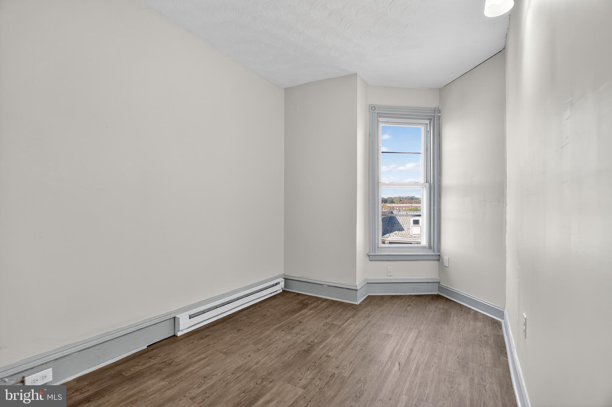 1259 North 10th Street Reading, PA 19604 - Photo 28 of 36 a view of a room with wooden floor and window