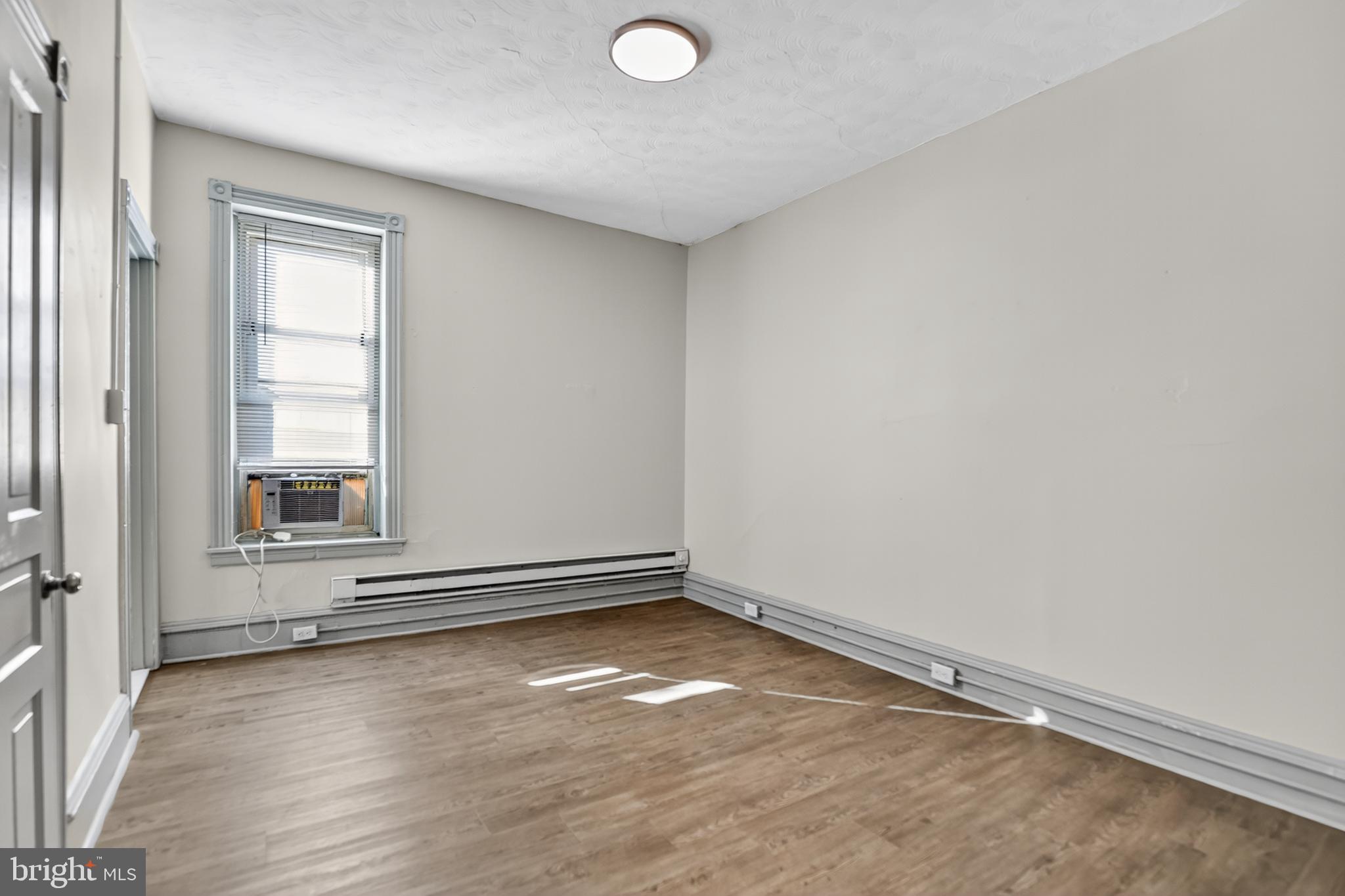 1259 North 10th Street Reading, PA 19604 - Photo 30 of 36 an empty room with wooden floor and windows
