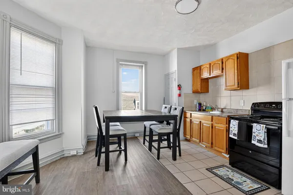 a view of an empty room and wooden floor and closet