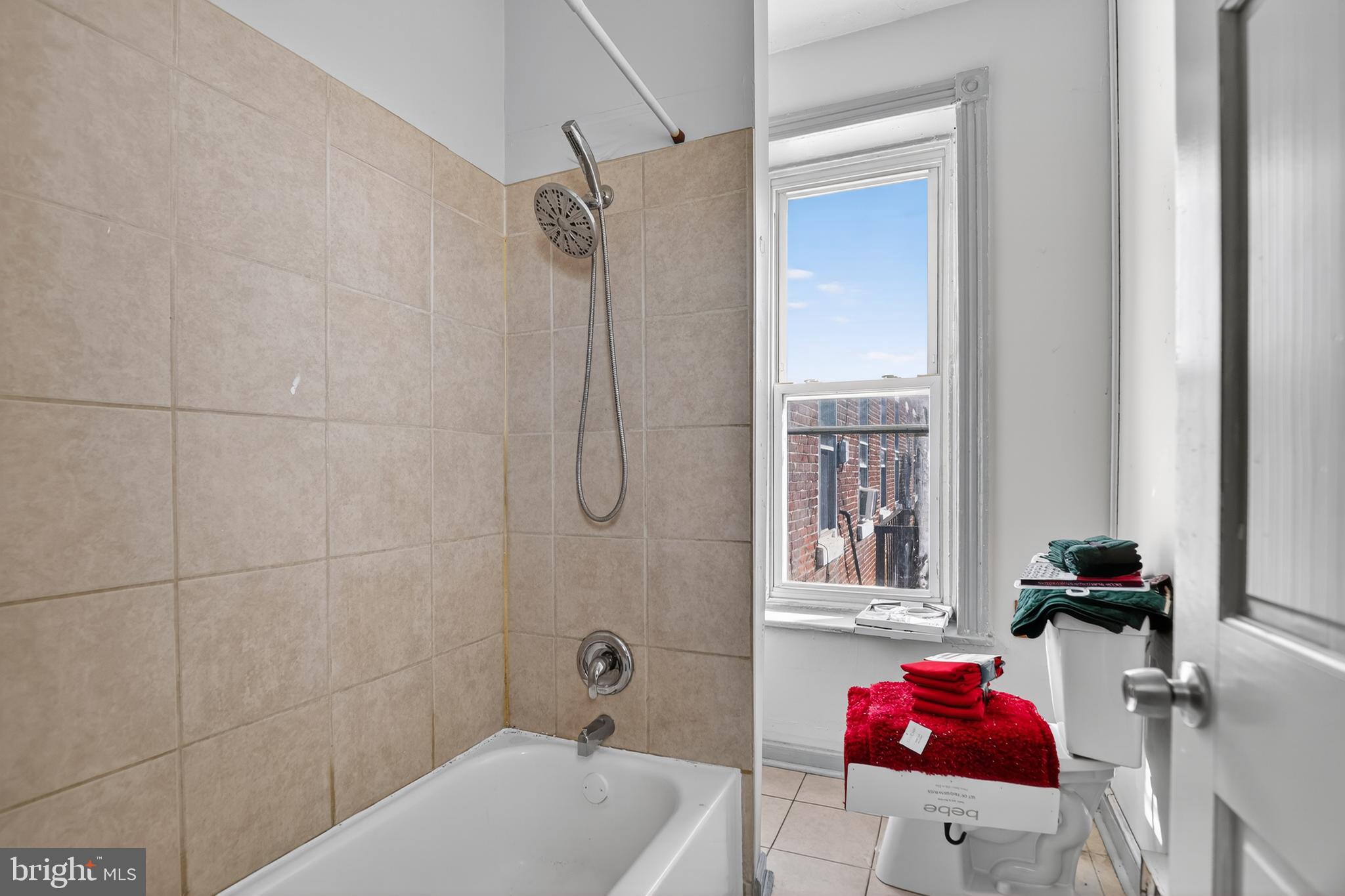 1259 North 10th Street Reading, PA 19604 - Photo 36 of 36 a bathroom with a tub shower vanity and a sink