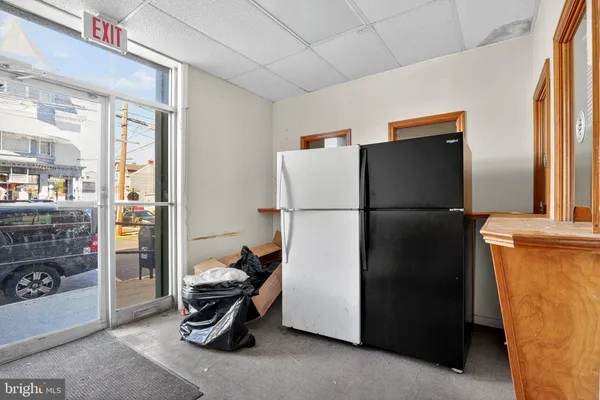 a refrigerator freezer sitting in a kitchen with stainless steel appliances wooden floor and a cabinet