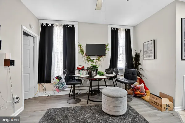 a living room with furniture and large windows