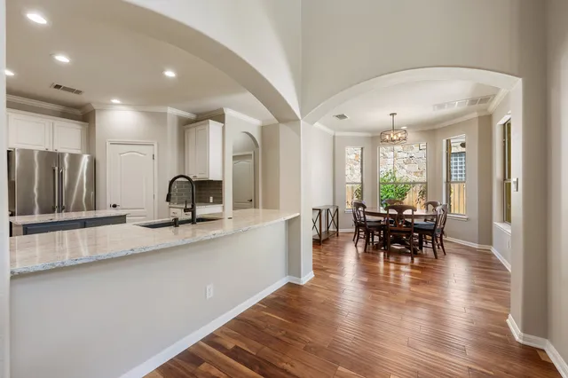 a large kitchen with a table and chairs