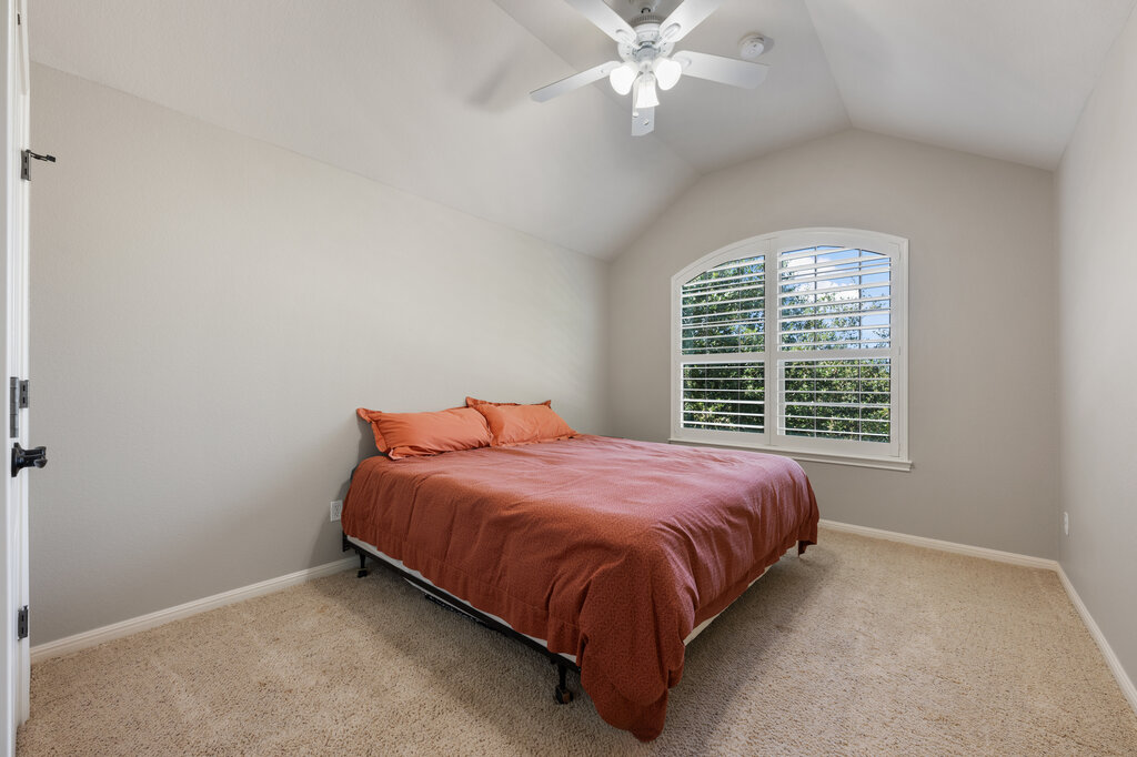 12801 Little Dipper Path Austin, TX 78732 - Photo 22 of 29 a bed sitting in a bedroom next to a window