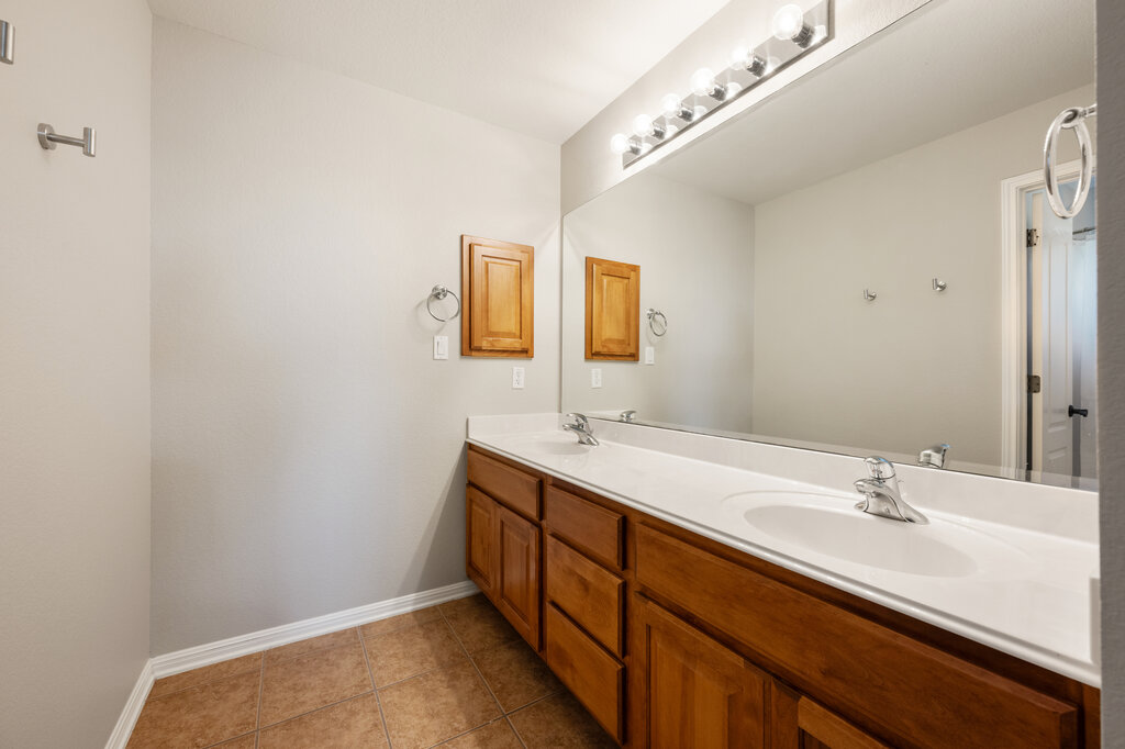 12801 Little Dipper Path Austin, TX 78732 - Photo 25 of 29 a bathroom with a double vanity sink and mirror