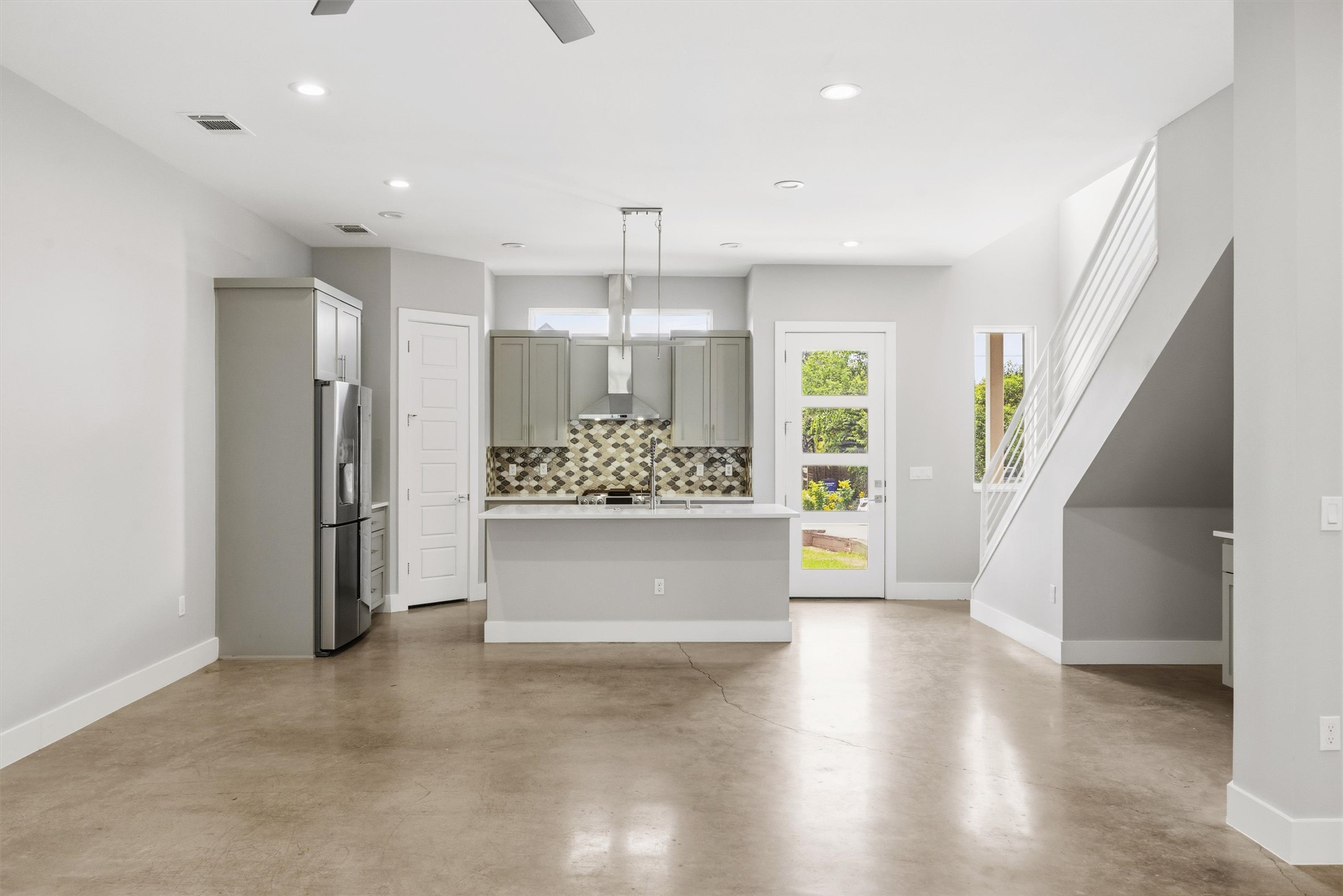 1210 Stobaugh Street, Unit B Austin, TX 78757 - Photo 32 of 40 A modern kitchen island with ample counter space anchors this open-concept living area.