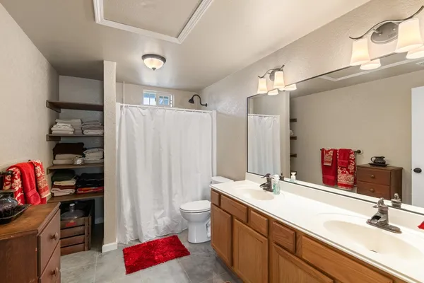 a bathroom with a sink double vanity and a shower