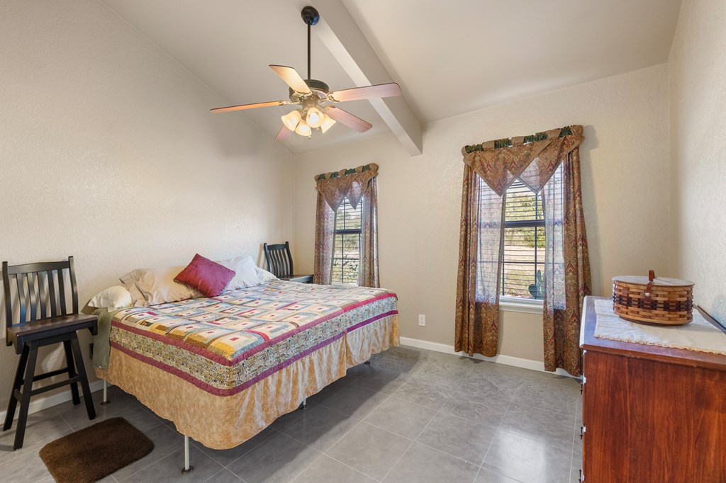 4980 West Ranch Road 1674 Junction, TX 76849 - Photo 14 of 23 a bedroom with a bed and a chandelier