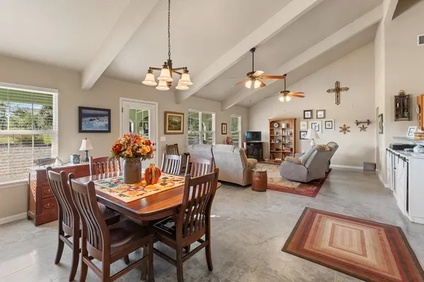 a view of a dining room with furniture and a chandelier