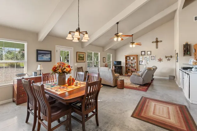 a view of a dining room with furniture and a chandelier