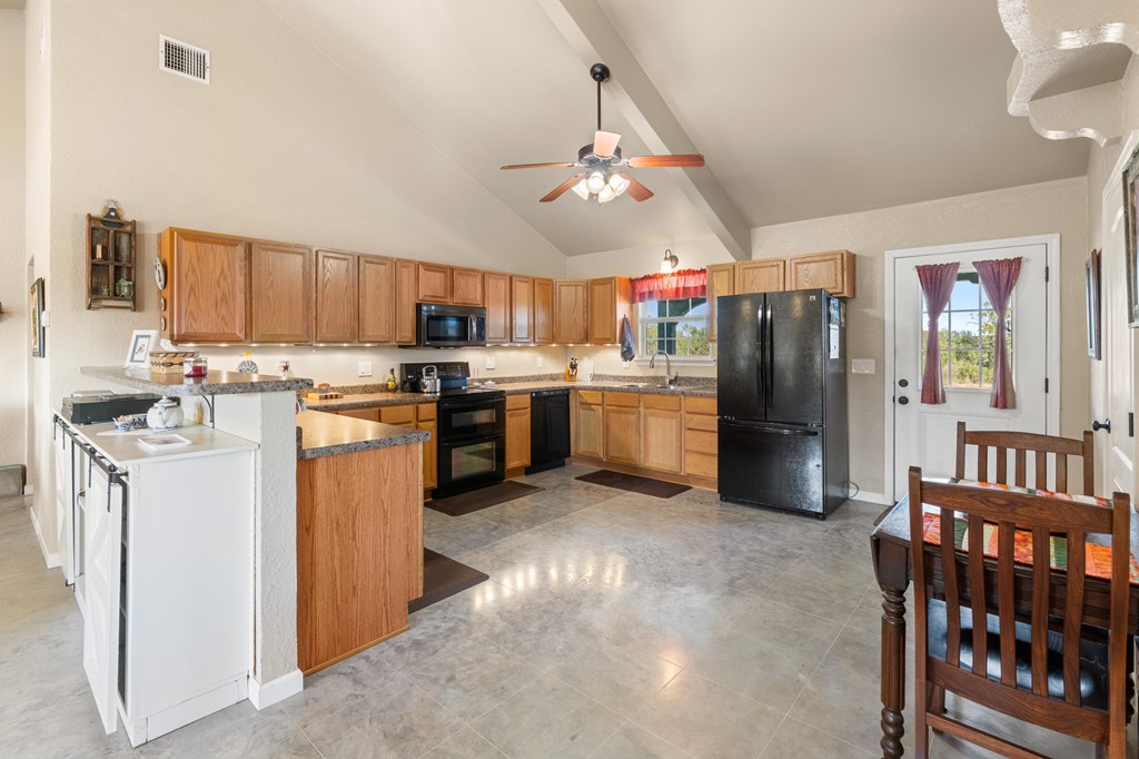 4980 West Ranch Road 1674 Junction, TX 76849 - Photo 6 of 23 a kitchen with stainless steel appliances granite countertop a stove refrigerator sink and dishwasher