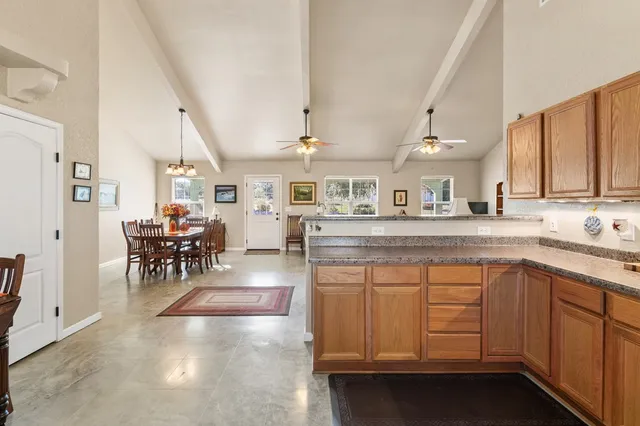 a kitchen with sink cabinets and dining table chair