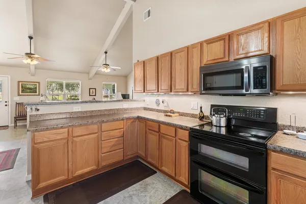 a kitchen with a sink stove and microwave