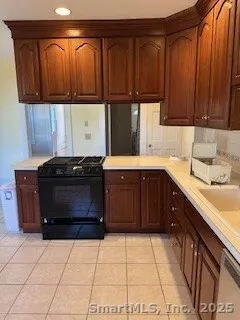 a kitchen with a sink a stove and cabinets