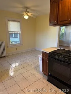 a stove top oven sitting inside of a kitchen