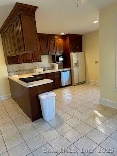 a kitchen with stainless steel appliances granite countertop a sink stove and a refrigerator