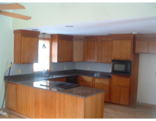 115 High Street Carver, MA 02330 - Photo 7 of 8 a kitchen with a sink cabinets and a window
