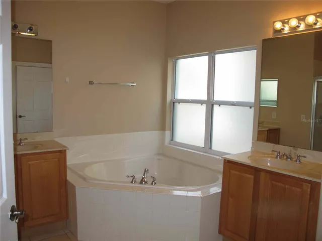 a bathroom with a bathtub and a window