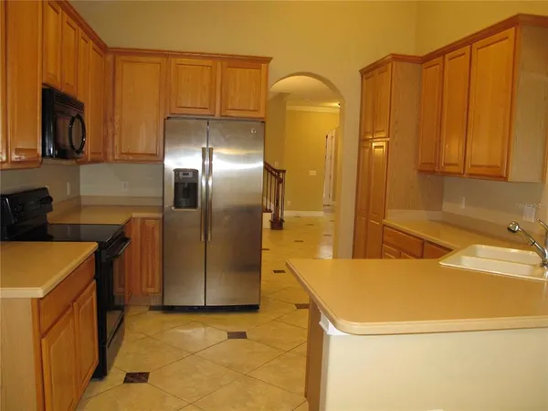 a bathroom with a sink and a refrigerator