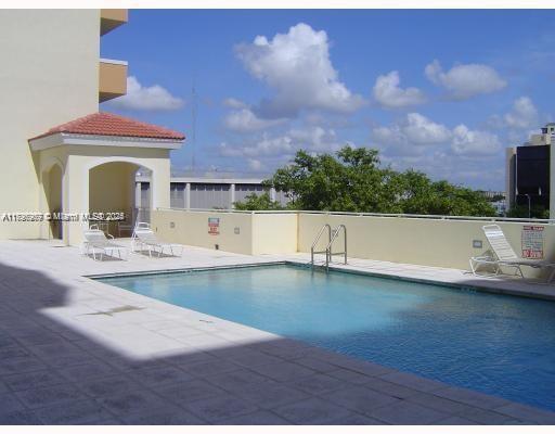 215 Southwest 42nd Avenue, Unit 905 Miami, FL 33134 - Photo 14 of 18 a view of a living room and kitchen