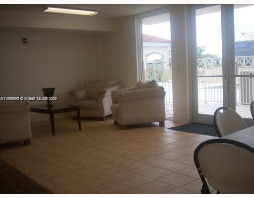 215 Southwest 42nd Avenue, Unit 905 Miami, FL 33134 - Photo 15 of 18 a living room with furniture and a large window