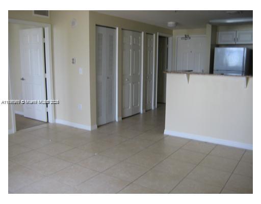 215 Southwest 42nd Avenue, Unit 905 Miami, FL 33134 - Photo 2 of 18 a view of an empty room with closet and utility room
