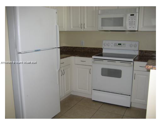 215 Southwest 42nd Avenue, Unit 905 Miami, FL 33134 - Photo 7 of 18 a utility room with dryer and washer
