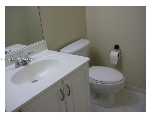 215 Southwest 42nd Avenue, Unit 905 Miami, FL 33134 - Photo 9 of 18 a bathroom with a sink a toilet and mirror
