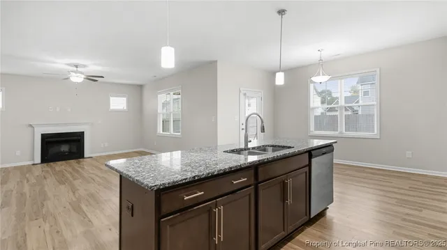 a kitchen with stainless steel appliances granite countertop a kitchen island a refrigerator and a sink
