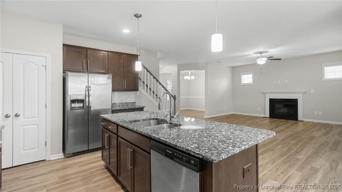 160 Chatfield Dr. Raeford, NC 28376 - Photo 15 of 32 a kitchen with stainless steel appliances granite countertop a kitchen island a refrigerator and a sink