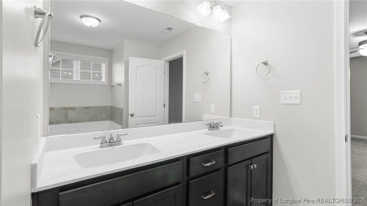 160 Chatfield Dr. Raeford, NC 28376 - Photo 27 of 32 a bathroom with a sink double vanity and a mirror