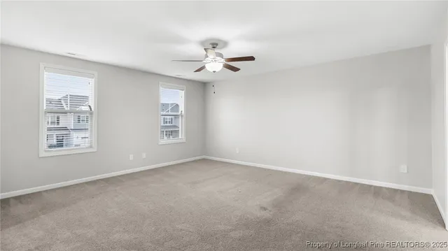 a view of a brick house with wooden fence