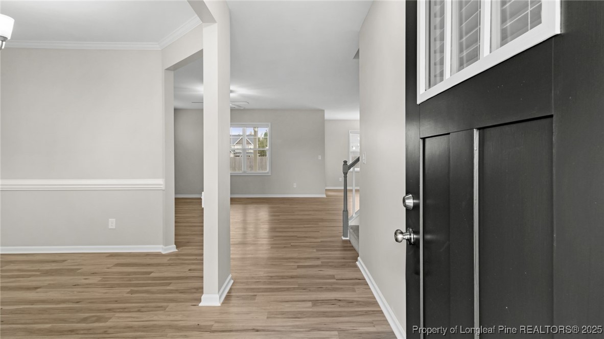 160 Chatfield Dr. Raeford, NC 28376 - Photo 5 of 32 a view of a hallway with wooden floor and staircase