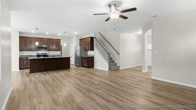 a view of kitchen with sink and wooden floor