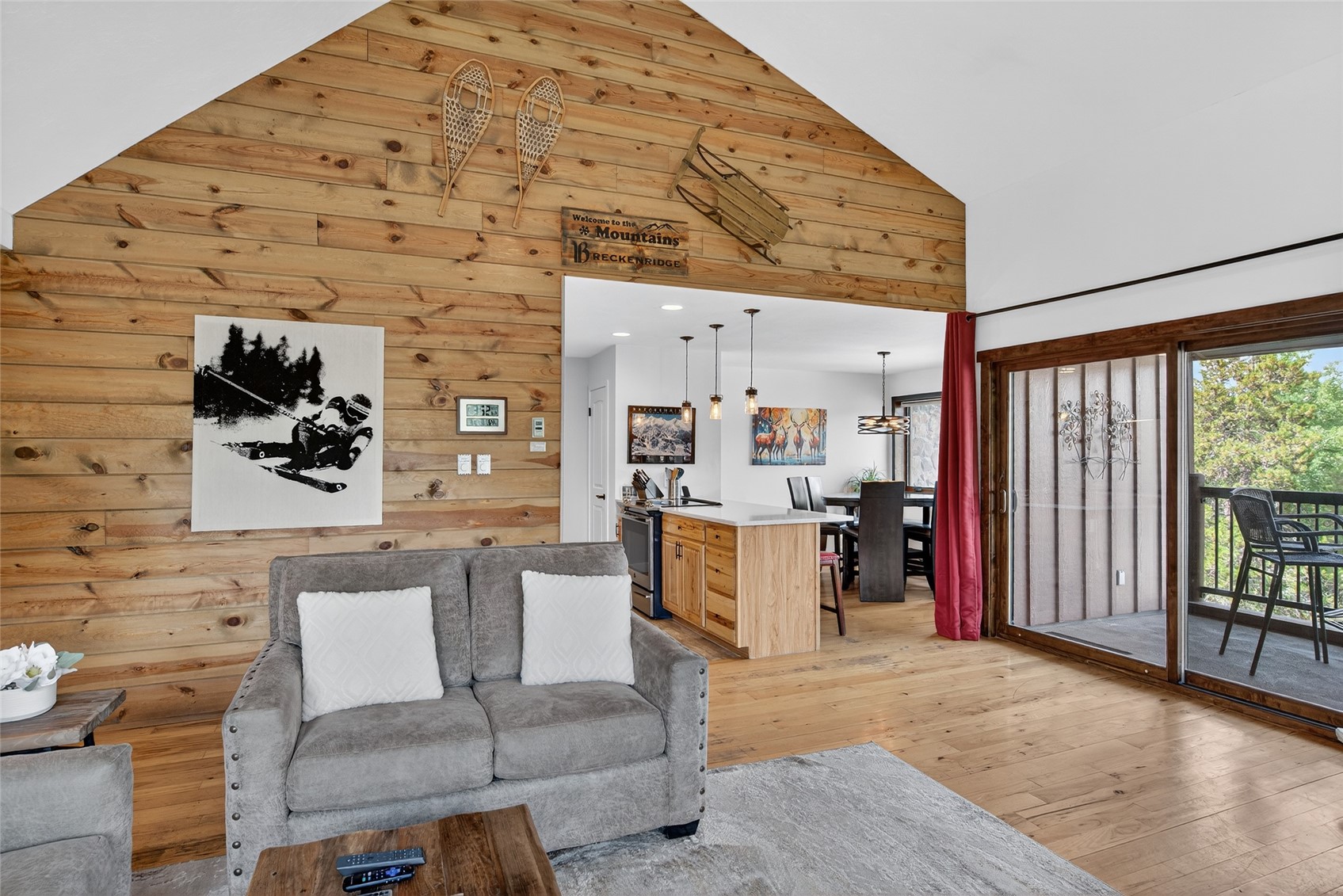 325 Four Oclock Road, Unit A301 Breckenridge, CO 80424 - Photo 10 of 41 Living room with wooden walls, high vaulted ceiling, and light wood finished floors