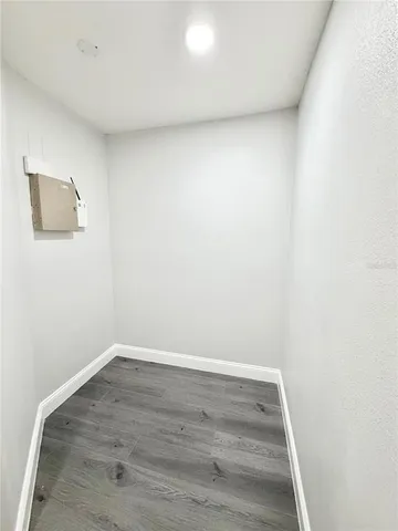 a view of room with wooden floor