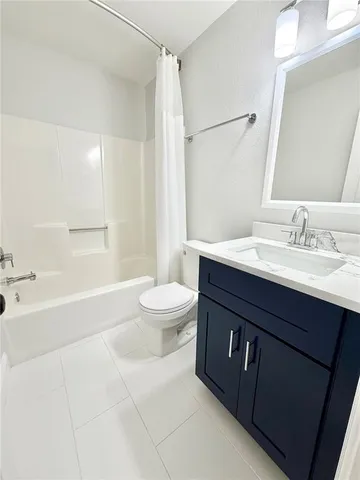 a bathroom with a sink a toilet and a large mirror