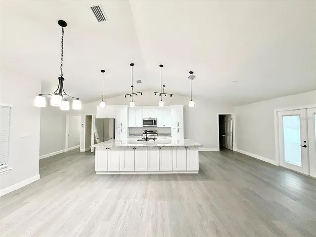 a view of kitchen with furniture and wooden floor