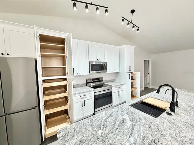 a kitchen with a refrigerator stove and a sink
