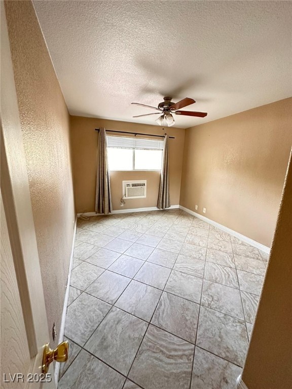 5346 South Swenson Street, Unit 35 Las Vegas, NV 89119 - Photo 5 of 19 Empty room featuring a textured wall, ceiling fan, light tile patterned floors, and a textured ceiling
