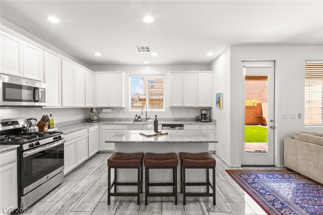 6435 Point Isabel Way Las Vegas, NV 89122 - Photo 12 of 57 Culinary delights await in this bright kitchen with a spacious island, perfect for entertaining.