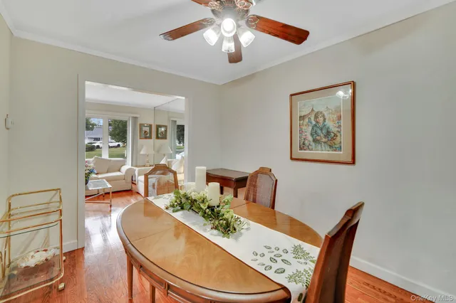 a view of a dining room with furniture wooden floor and chandelier