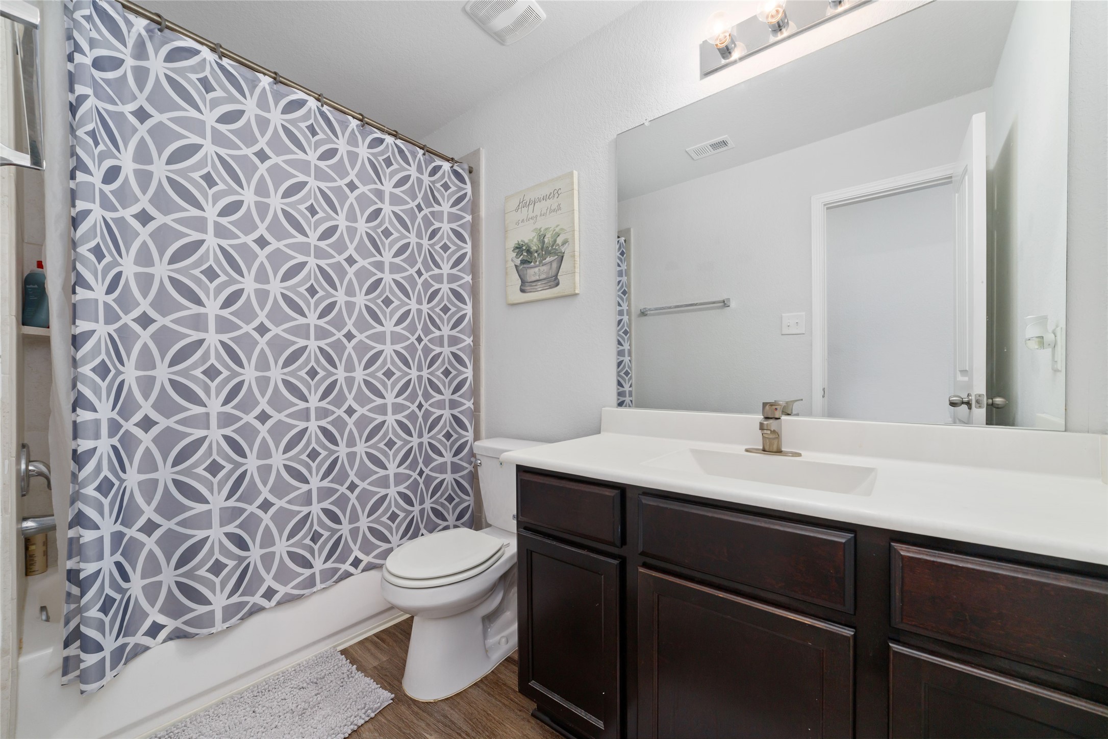 18619 Cooper Ravine Way Katy, TX 77449 - Photo 21 of 23 a bathroom with a granite countertop sink a toilet and a mirror
