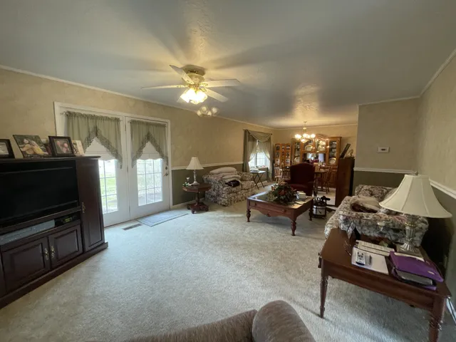a living room with furniture hard wood floor and a rug