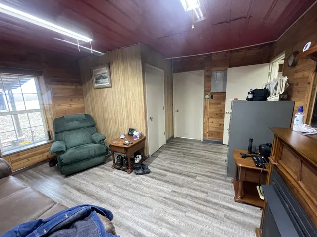 a kitchen with a refrigerator a stove a sink dishwasher and wooden cabinets with wooden floor