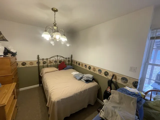 a bedroom with furniture and a window