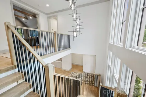a living room with furniture large window and wooden floor
