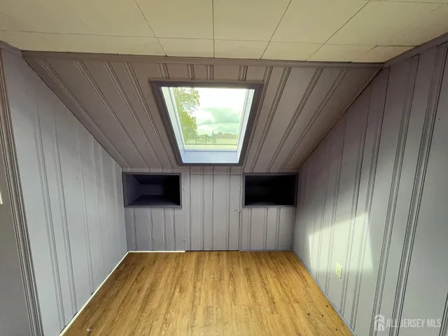 a view of a livingroom with wooden floor and window
