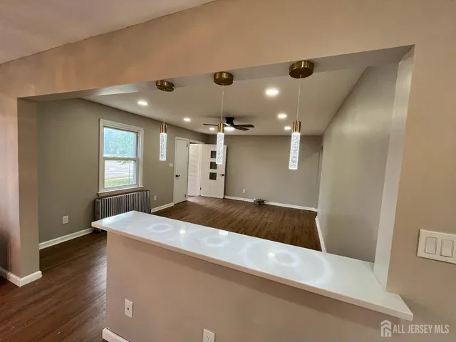 a kitchen with kitchen island a sink stainless steel appliances and cabinets