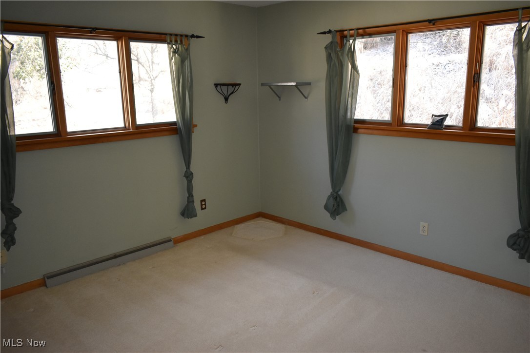 735 Sheridan Road Coshocton, OH 43812 - Photo 23 of 34 Unfurnished room featuring a baseboard heating unit and carpet flooring